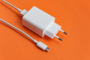 Charger and usb cable type c over orange background
